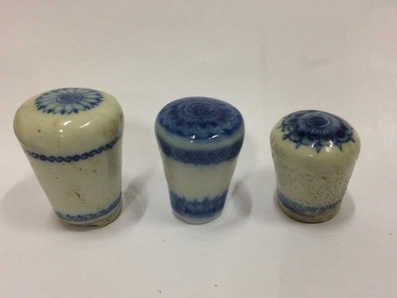 Photo. The knobs are a faded white and blue, with different patterns